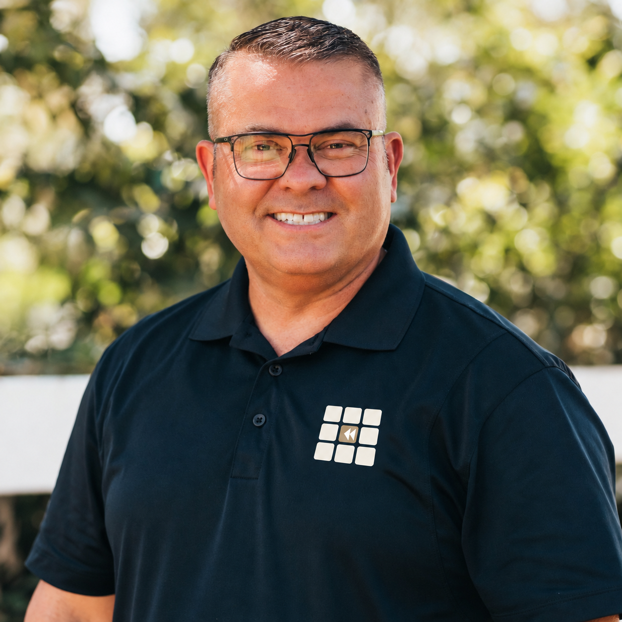 Mike, founder of Nine Grid Rewind, smiling in a Nine Grid Rewind polo